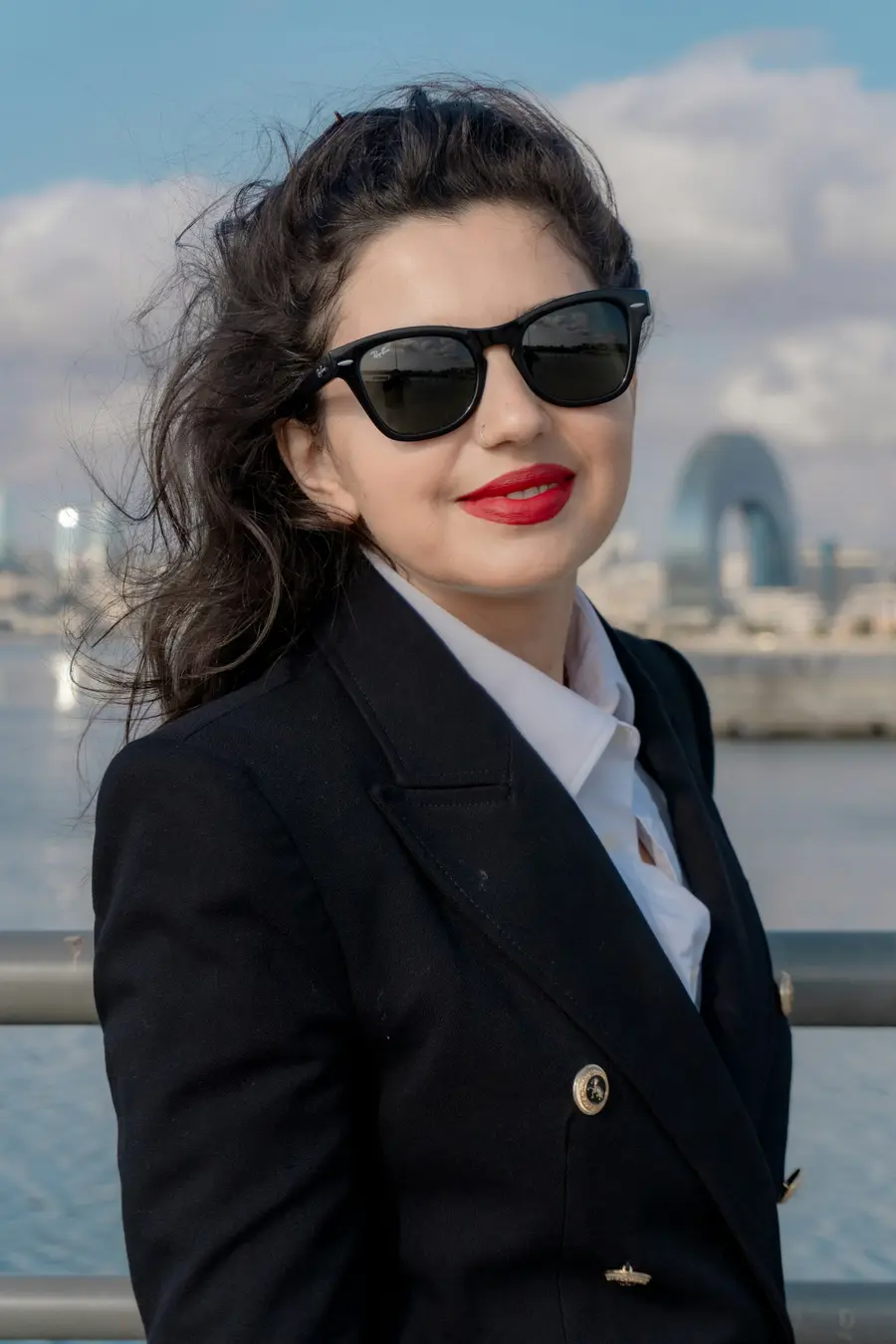 Mulher de blazer preto e óculos escuros