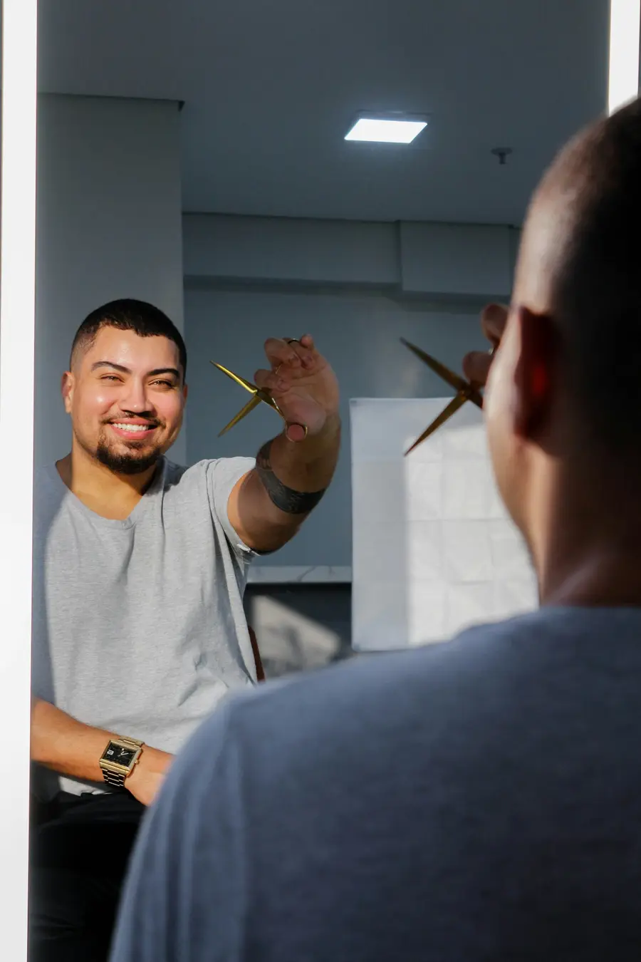 Pai e filho escovando os dentes juntos diante do espelho, banheiro claro, tons de branco e azul